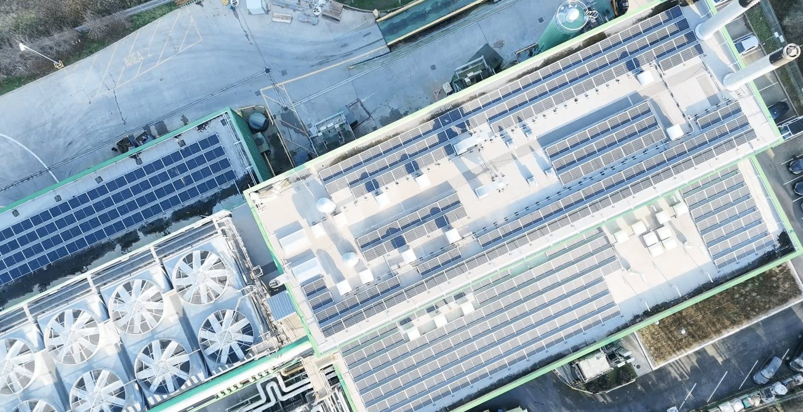 Commercial rooftop solar array installed alongside existing plant equipment